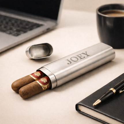 Cigar case with cigars labeled 'JOEY' on a desk with a laptop and coffee cup.