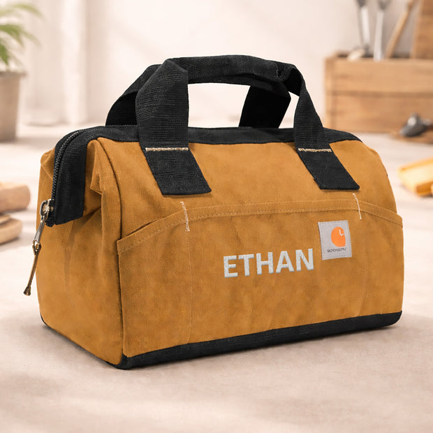 Brown tool bag with black handles and 'Ethan' branding on a light background