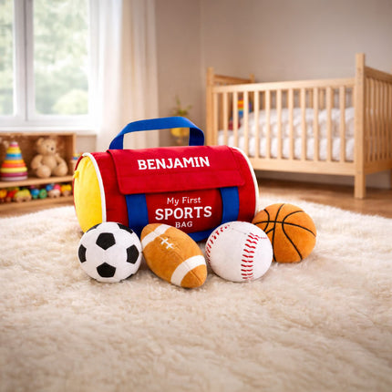 Children's toy sports bag with plush sports balls on a carpeted floor.