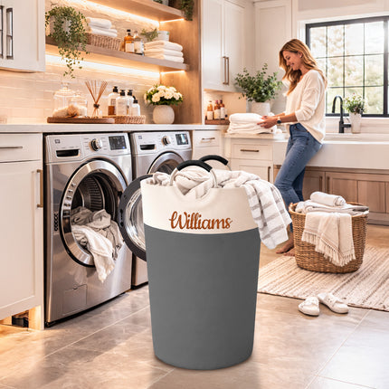 Woman in a laundry room with a 'Williams' branded laundry basket.