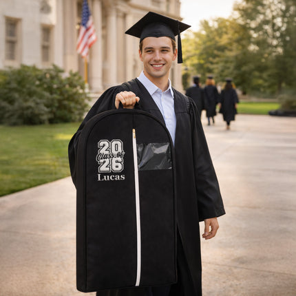 Graduate in cap and gown holding a personalized backpack with '20 Class of 26 Lucas' text on a campus background.