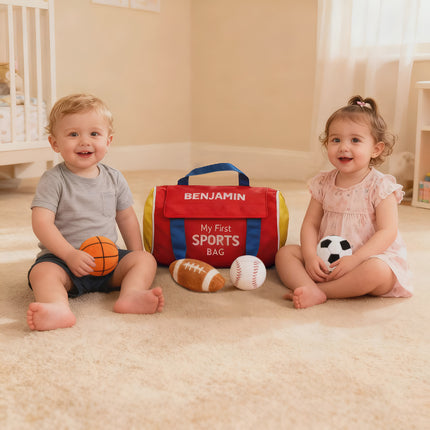 Two children sitting on a carpeted floor with a 'My First Sports Bag' named 'Benjamin'.