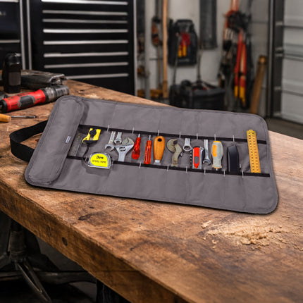 Tool roll with various tools on a wooden workbench in a garage setting