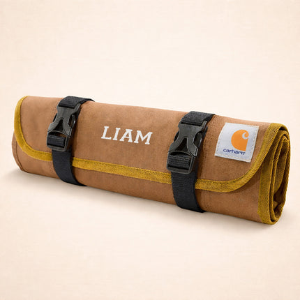 Brown roll-up bag with 'LIAM' branding and Carhartt logo on a beige background