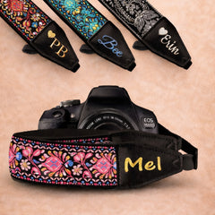 Camera strap with floral design and embroidered name 'Mel' on a beige background