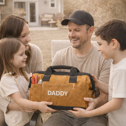 Family of four outdoors, with a father receiving a brown bag labeled 'Daddy'.