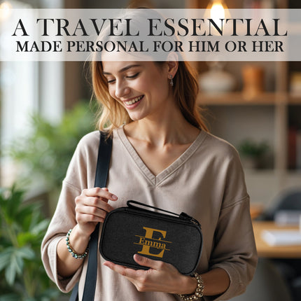 Woman holding a black travel case with 'Emma' branding, in a casual indoor setting.