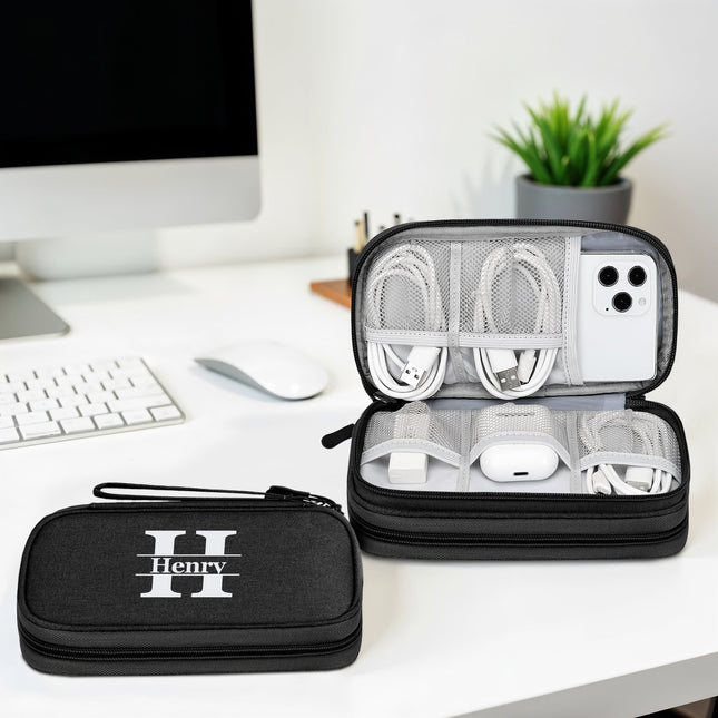 Black travel case with 'Henry' branding containing electronic devices on a desk.