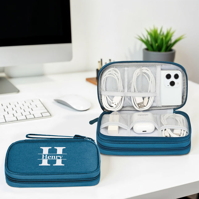 Blue carrying case with 'Henry' branding on a desk with electronic devices.
