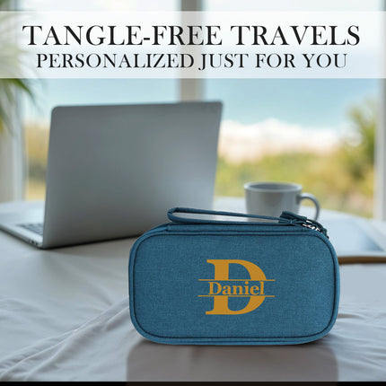 Blue travel case with 'Daniel' logo on a table with laptop and cup, text 'Tangle-Free Travels Personalized Just For You'.