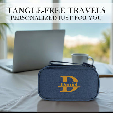 Blue travel organizer with 'Daniel' logo on a table with a laptop and cup, text 'Tangle-Free Travels Personalized Just For You'.