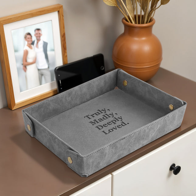 Personalized gray leather valet tray engraved with names. A meaningful gift for couples—perfect for anniversaries, weddings, or shared home décor.