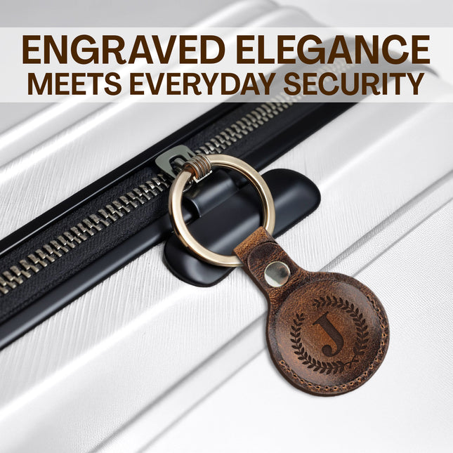 Brown leather keychain with engraved design attached to a black zipper on a white background.