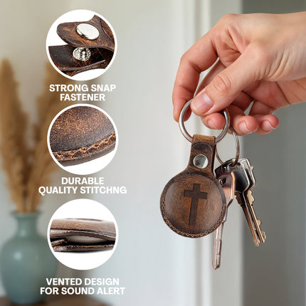 Brown leather keychain with cross design held by a hand, with close-up details and text on quality and features.