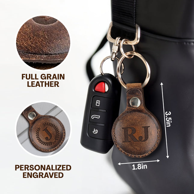 Brown leather keychain with 'RJ' engraving, attached to a car key fob, on a white background.