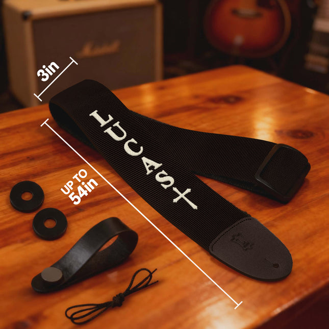 Black guitar strap with measurements on a wooden surface, featuring the brand 'Lucast'.