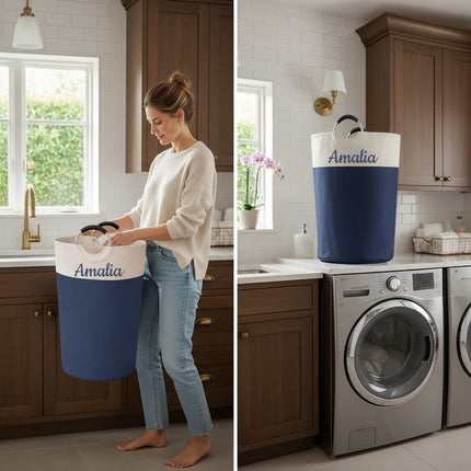 Woman holding a blue and white laundry basket labeled 'Amalia' in a kitchen, with another basket labeled 'Amalia' on a washing machine.