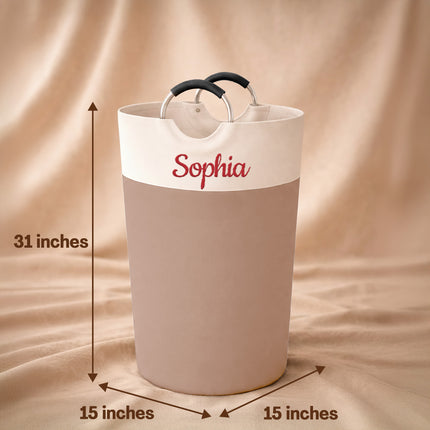 White laundry basket with 'Sophia' branding and dimensions on a beige background