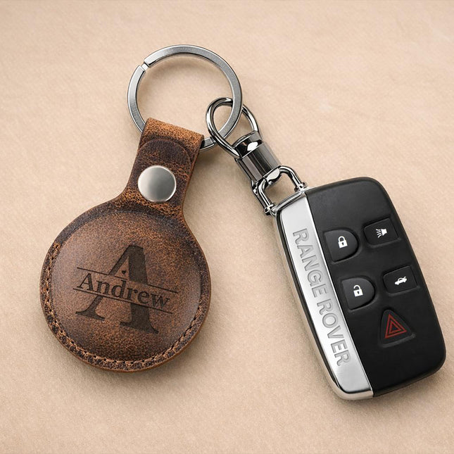 Keychain with leather tag and Range Rover key fob on a beige background