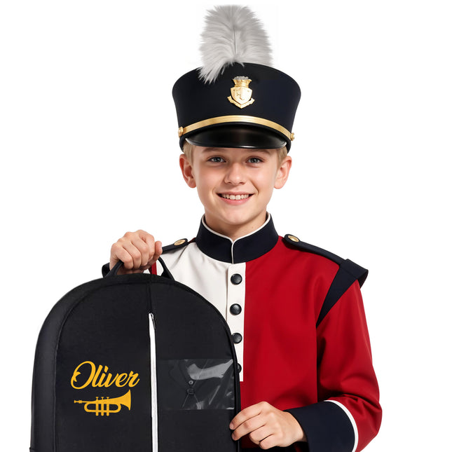 A young person in a marching band uniform holding a personalized garment bag with the name 'Oliver' printed on it.