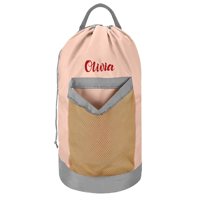 A pink personalized laundry bag with a mesh pocket, hanging shoulder strap, and custom text 'Olivia' printed on the front