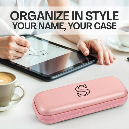 Pink case with letter 'S' on a desk with a tablet and coffee cups, text 'Organize in Style Your Name, Your Case'.