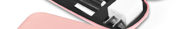 Pink case with black interior containing electronic accessories on a white background