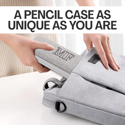 Gray pencil case with 'MIF' branding held by hands on a light background