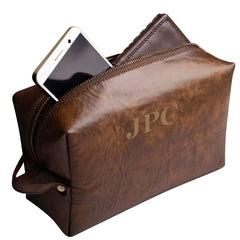 Brown leather pouch with 'JPC' branding and a phone inside on a white background