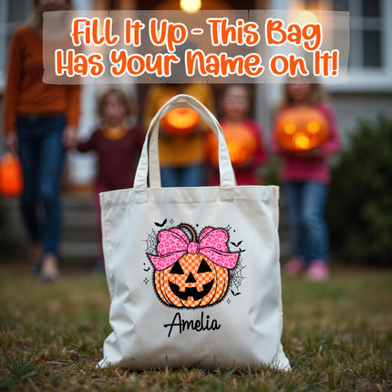 Halloween-themed tote bag with a pumpkin design and name 'Amelia' in front of blurred children holding pumpkins.