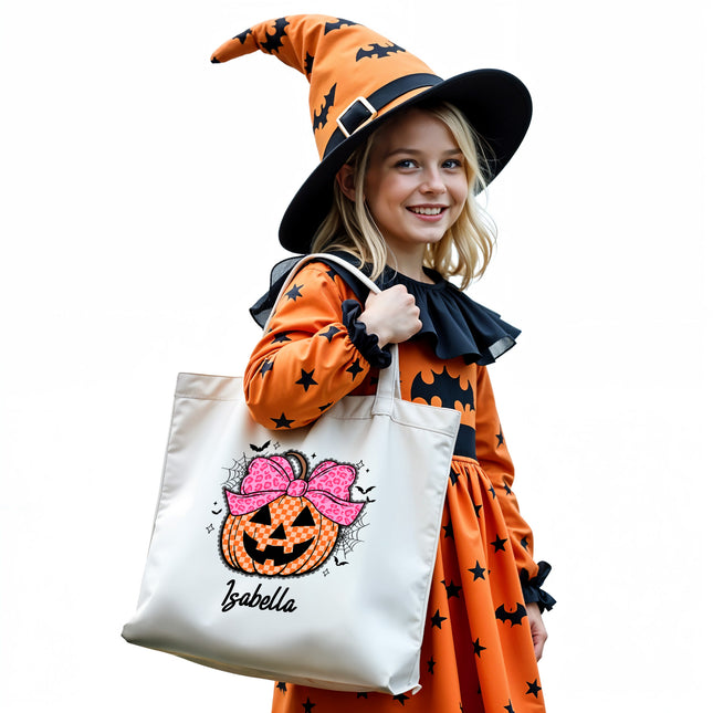 Child in Halloween costume holding a tote bag with a pumpkin design.