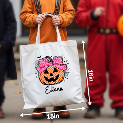 White tote bag with Halloween design held by a person, with measurements indicated.