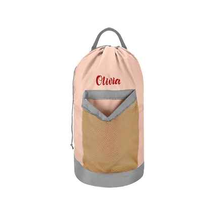 A pink personalized laundry bag with a mesh pocket, hanging shoulder strap, and custom text 'Olivia' printed on the front