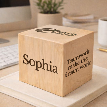 Wooden block with engraved name 'Sophia' and motivational quote on a desk.